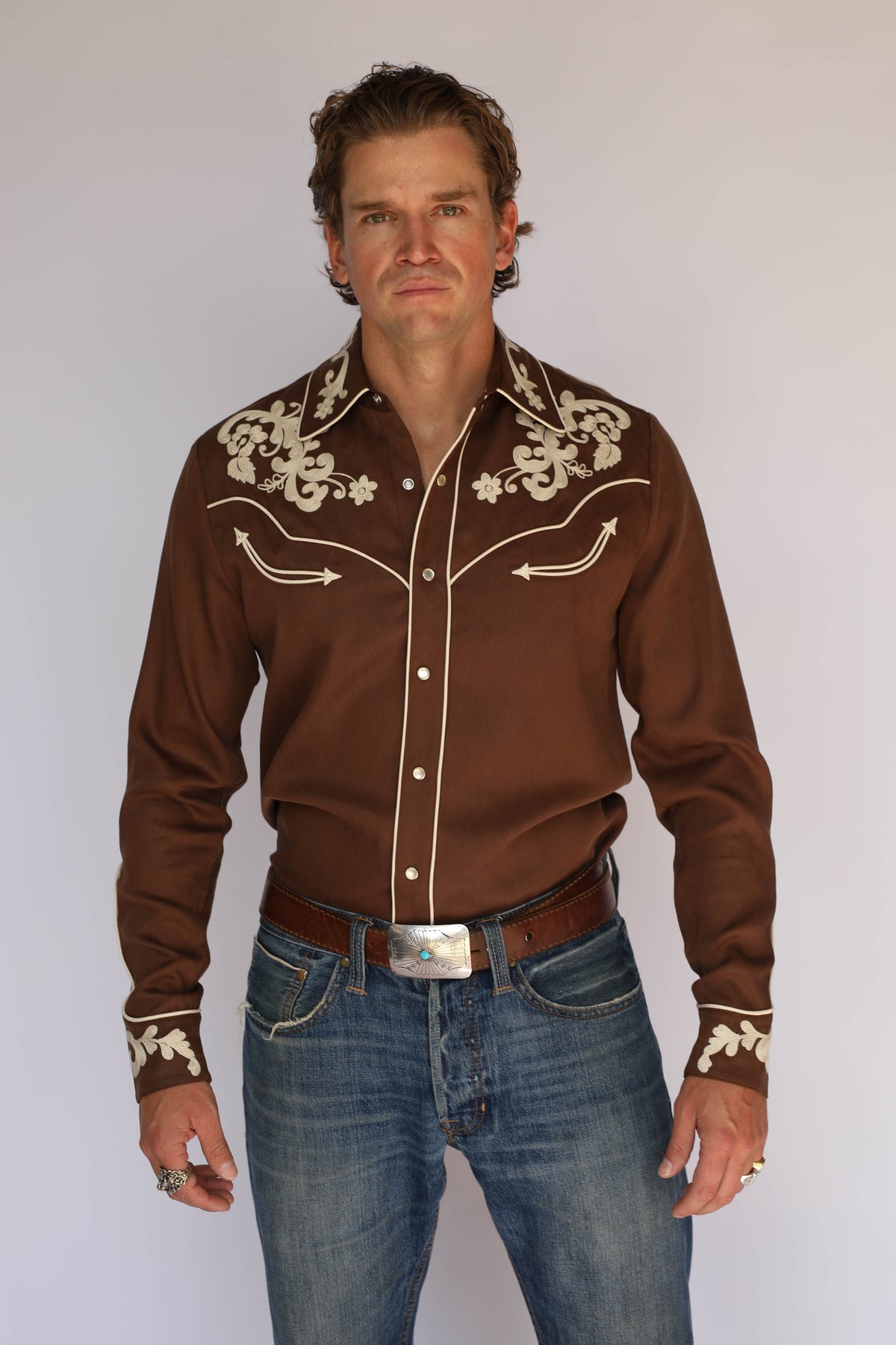 Front three-quarter view of the H Bar C Durango brown western shirt, vintage western wear with cream chain stitch embroidery on the yokes and collar.