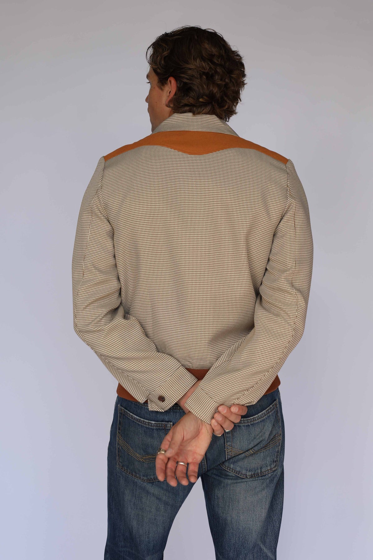 Back view of the H Bar C Kentucky brown houndstooth jacket with rust suede back yoke and ribbed hem.