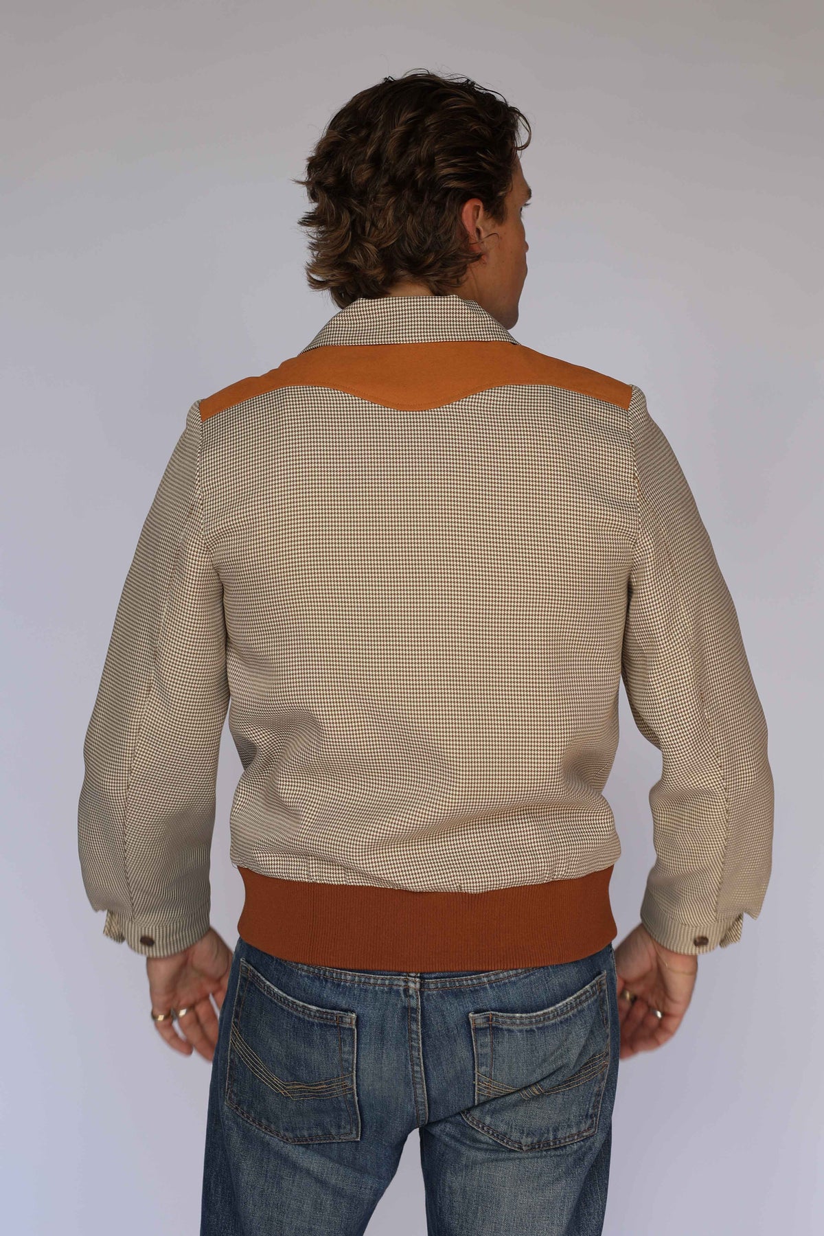 Rear view of the H Bar C Kentucky brown western jacket worn with jeans.
