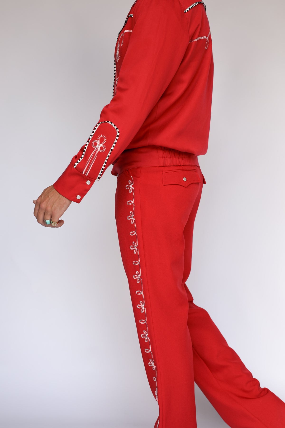 Model in the H Bar C Bolero red pants showing the embroidered leg detail.