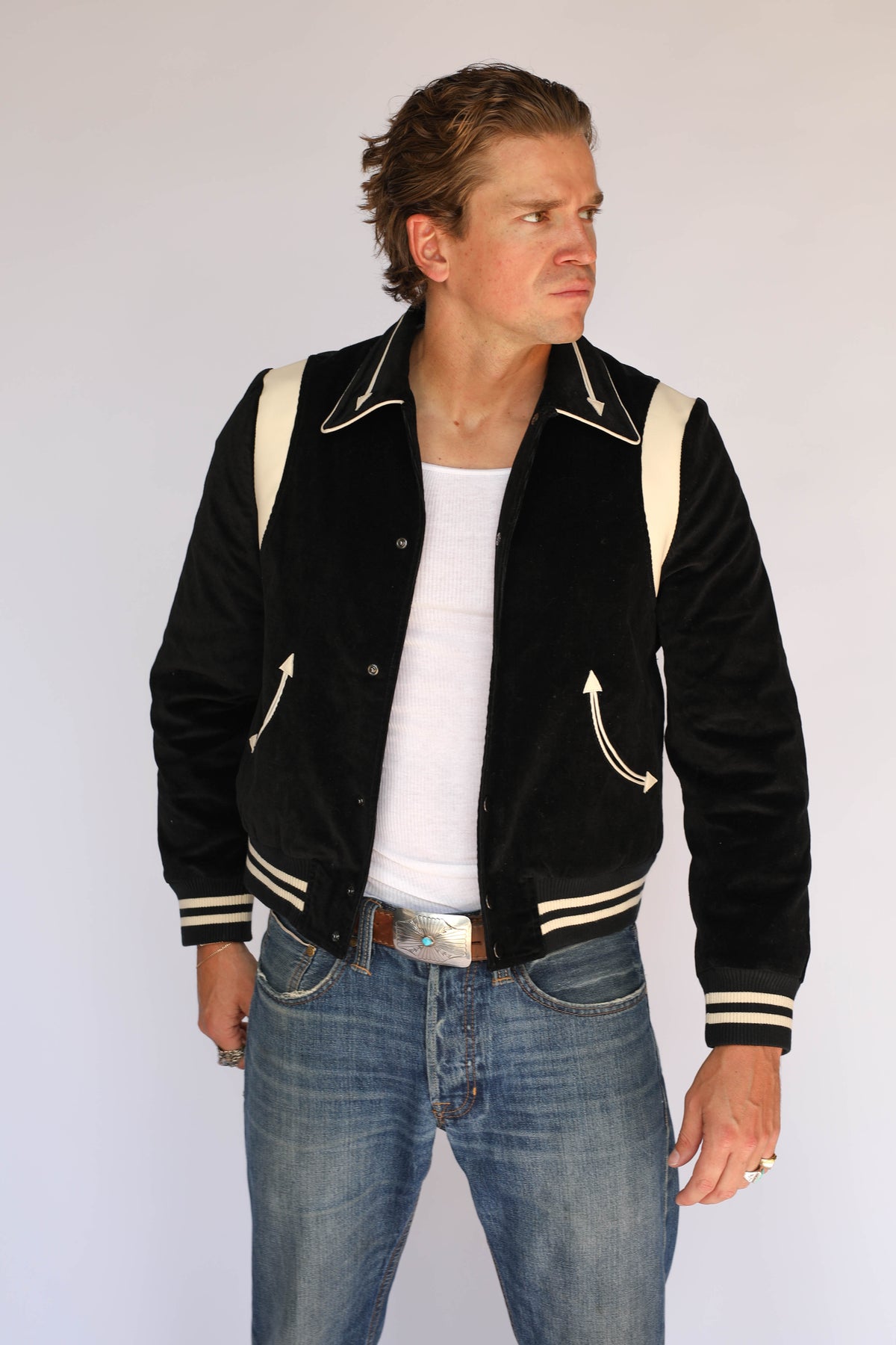 Man wearing the H Bar C Silver Lake black corduroy jacket, vintage inspired western wear with cream lambskin shoulder panels and arrow pockets.