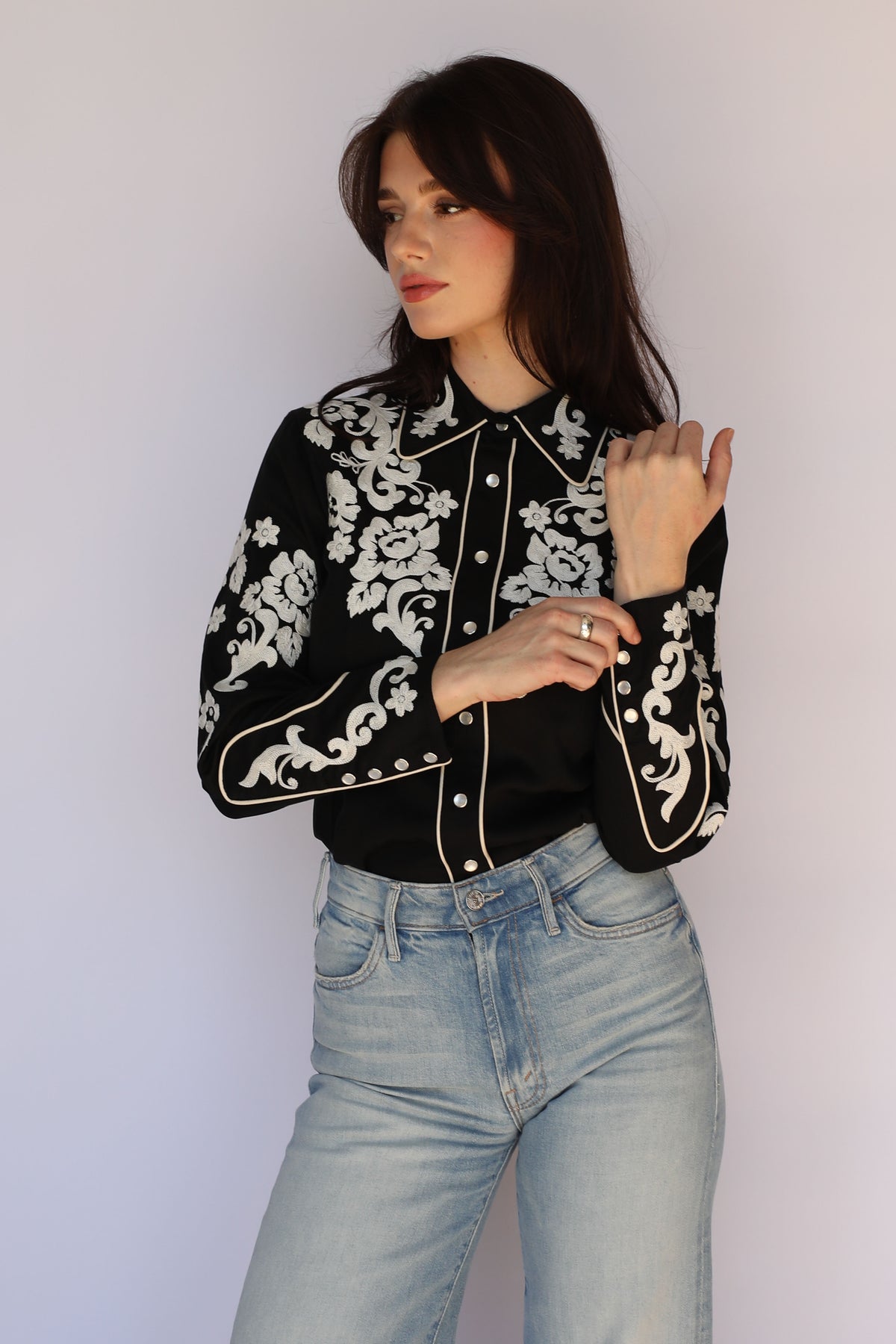 Side view of the H Bar C Fort Worth women's black shirt showing sleeve embroidery, vintage western wear.