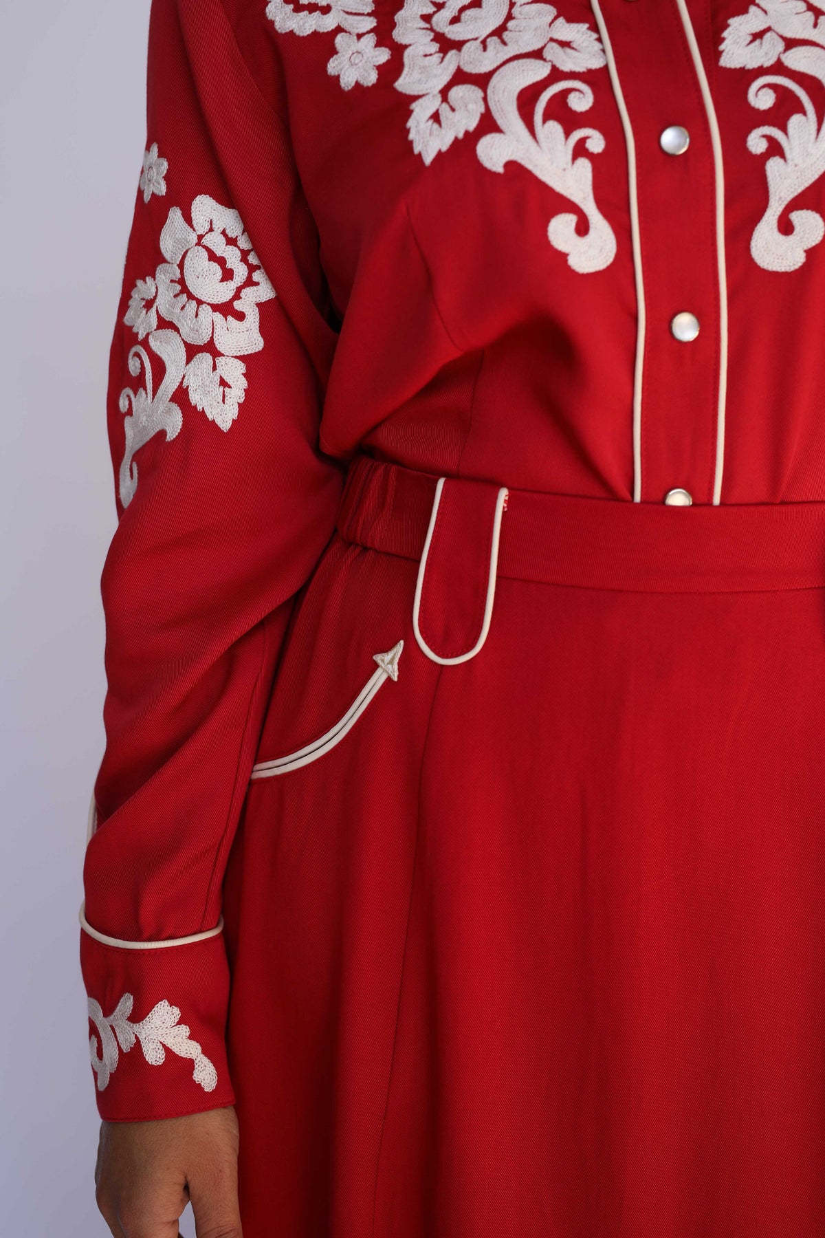 Close-up of the white piped pocket on the H Bar C Santa Fe women's red western skirt.