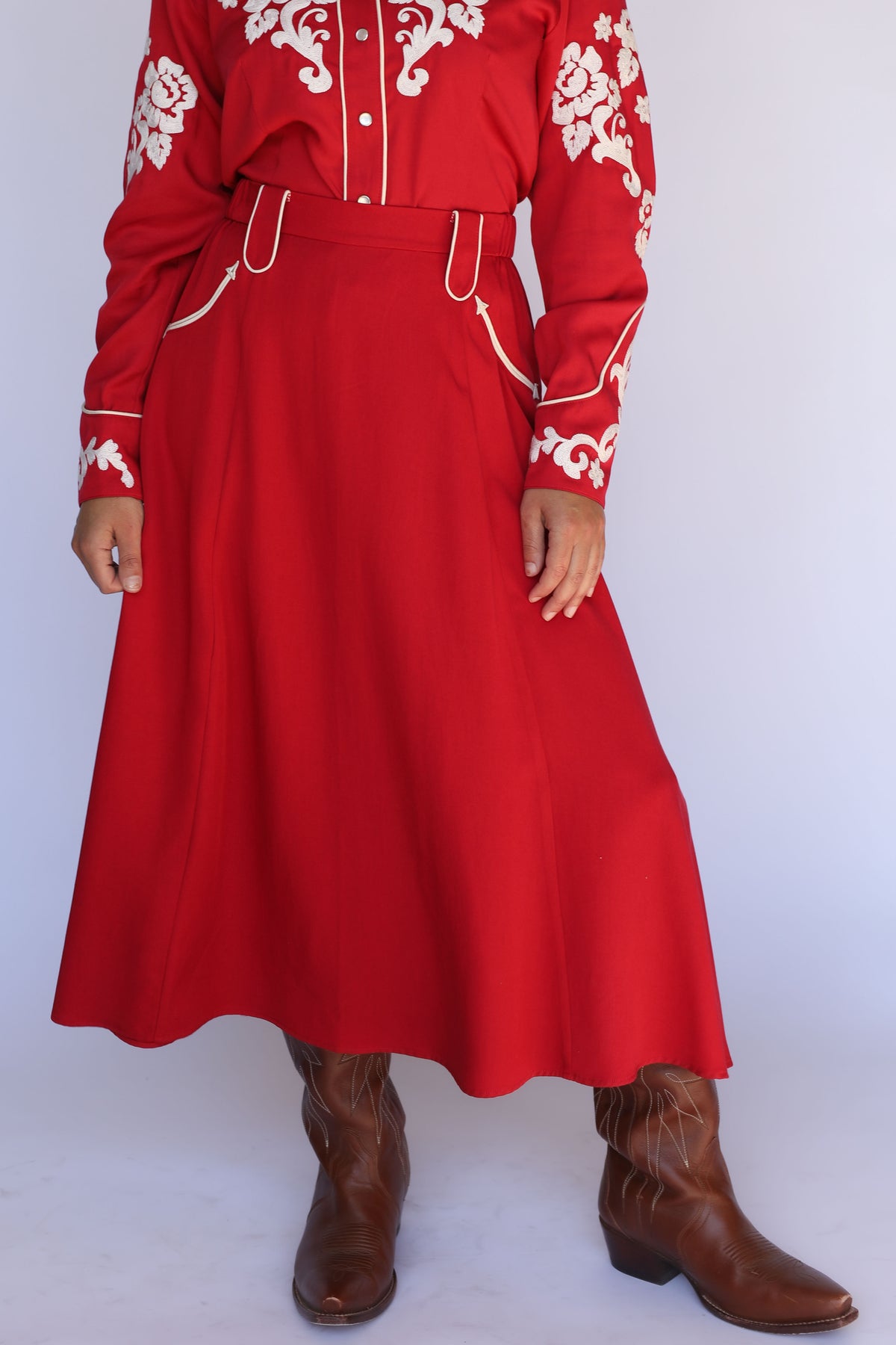 H Bar C Santa Fe women's skirt in red, a 1940s swing skirt with piped pockets, worn with a red embroidered western shirt and boots.