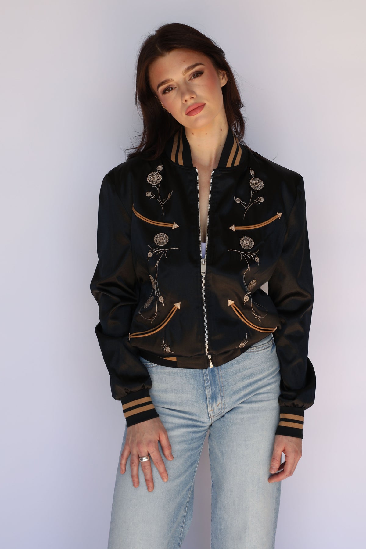 Woman wearing the H Bar C x Gibson J-200 Odessa Unisex Jacket in black satin, vintage inspired western wear