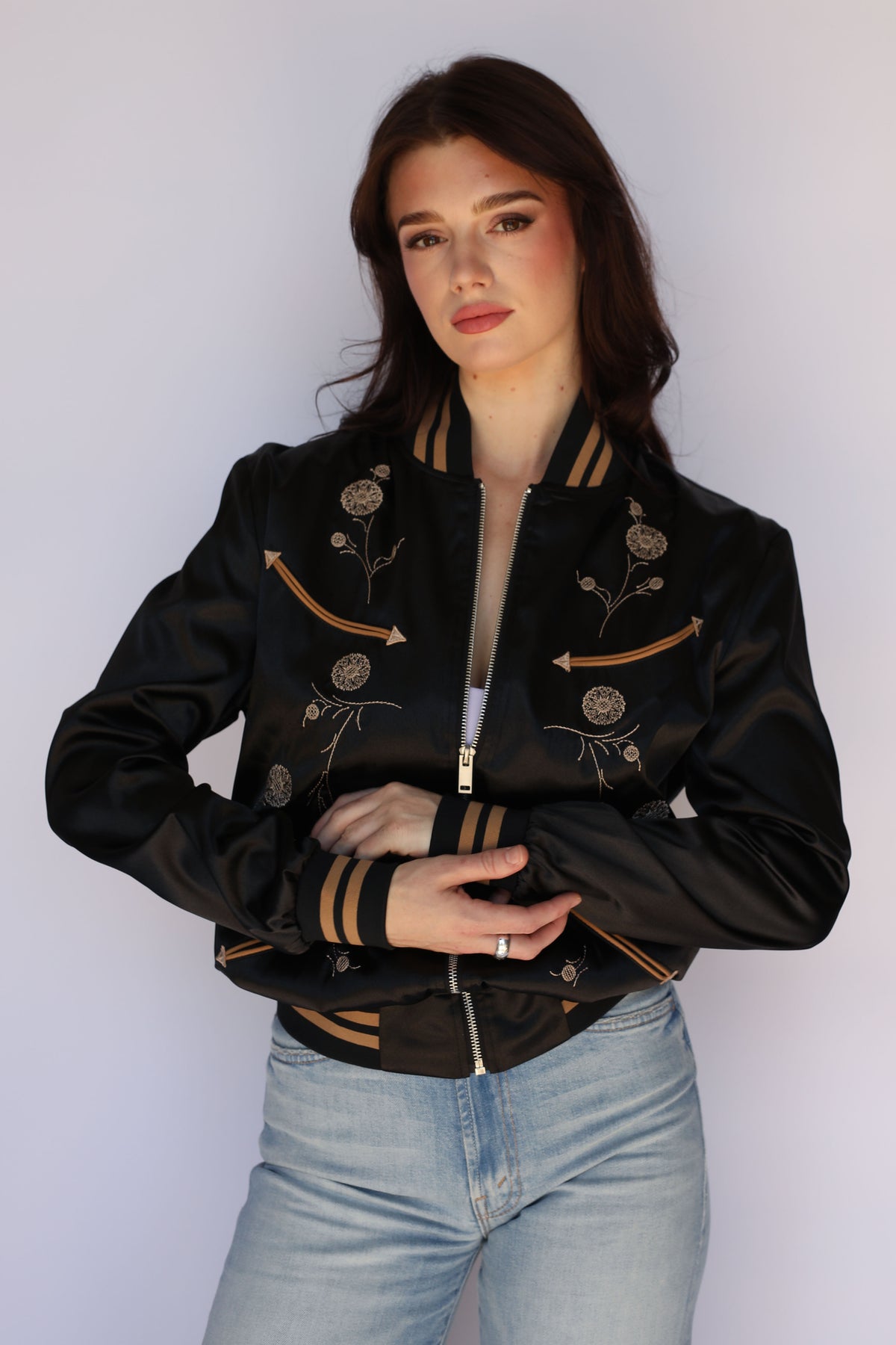Woman wearing the H Bar C x Gibson J-200 Odessa Unisex Jacket in black satin, vintage inspired western wear