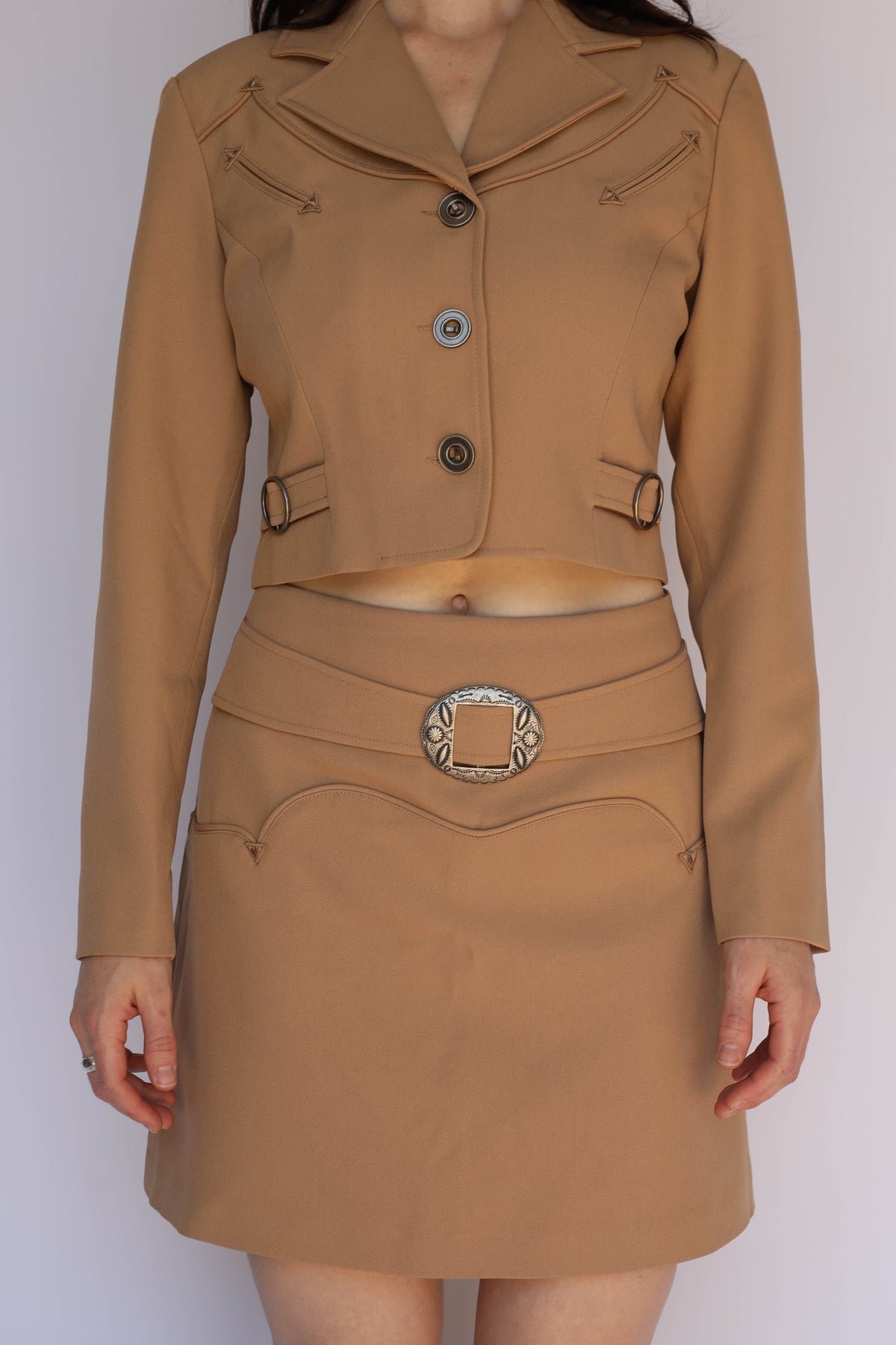 Woman wearing the full H Bar C Raleigh tan suit, vintage inspired western wear with arrow details.