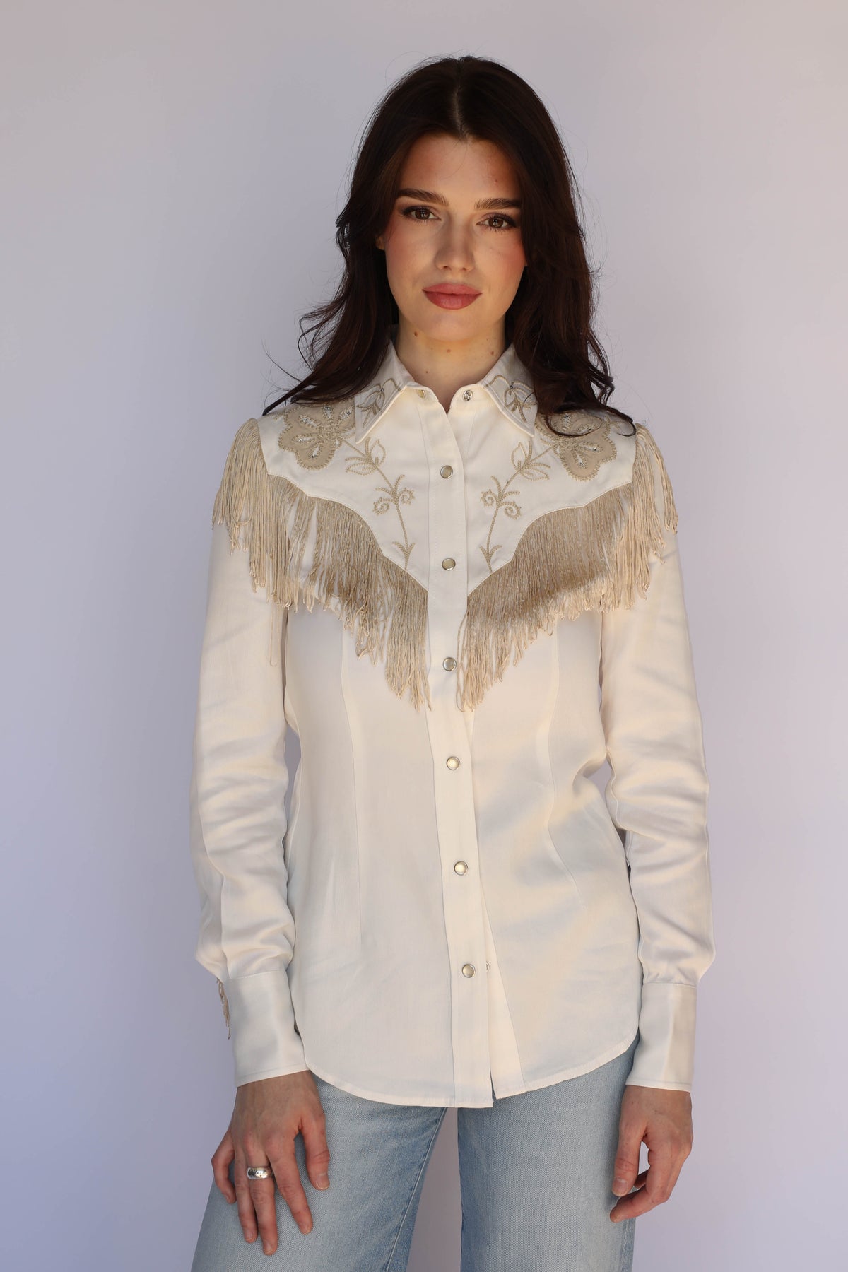 Woman wearing the H Bar C Taos women's white western shirt with long fringe across the yoke and sleeves, vintage inspired western wear.