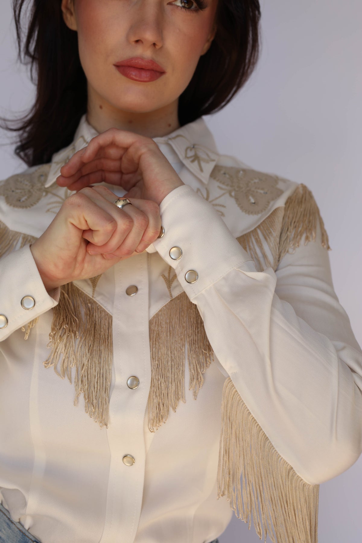 Detail of the fringed yoke and snap front on the H Bar C Taos women's white western shirt.