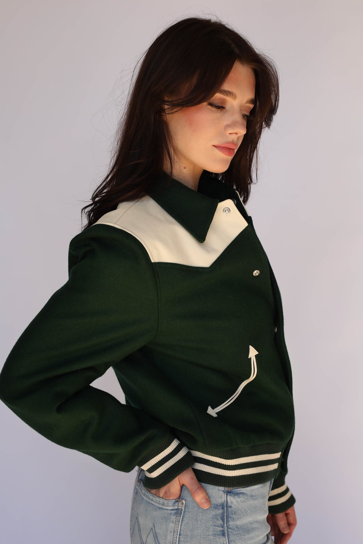 Three-quarter view of The Vail H Bar C green and cream jacket styled for women.