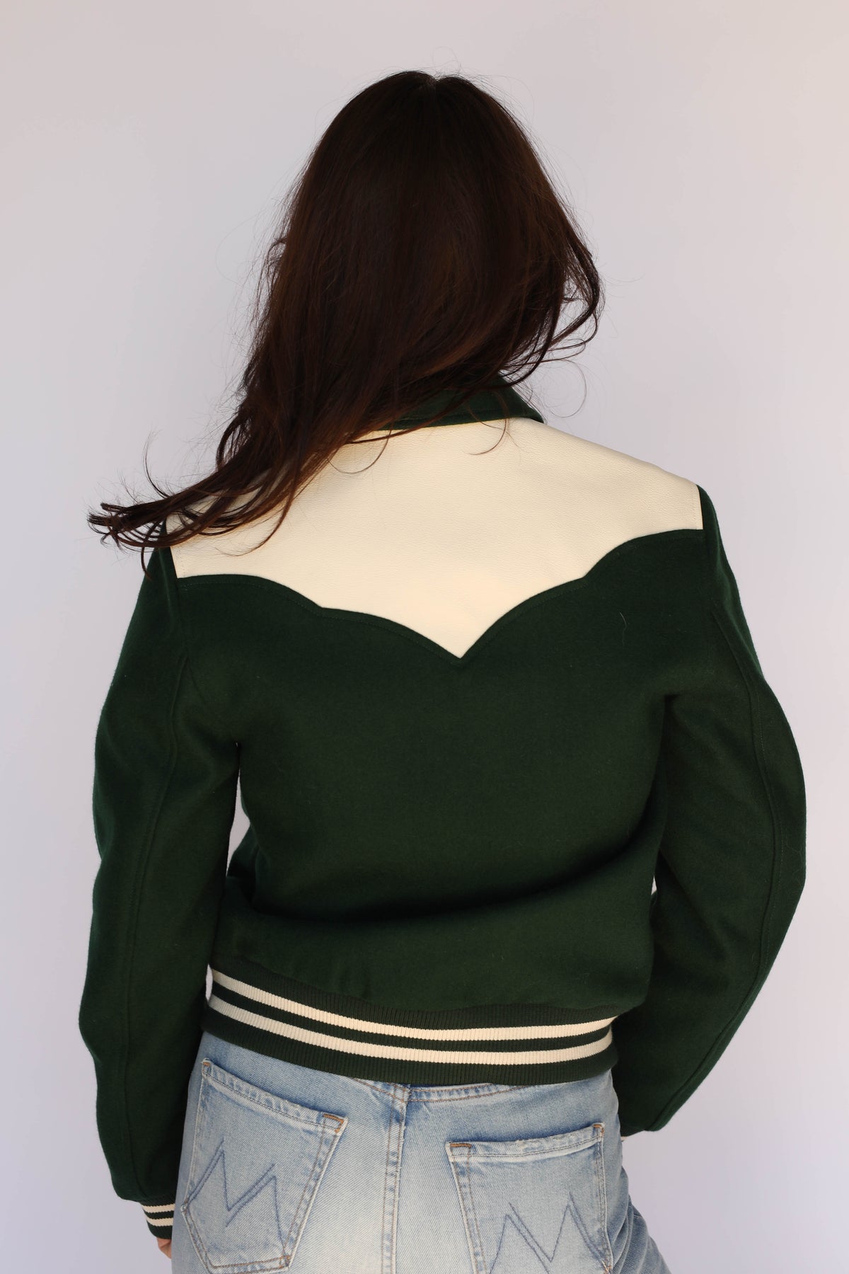 Rear view of The Vail unisex green jacket by H Bar C on a woman.