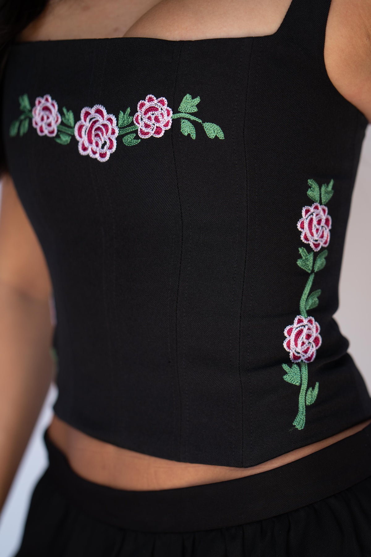Side detail of the chain stitched rose vine on the H Bar C Canterbury black corset with structured boning.
