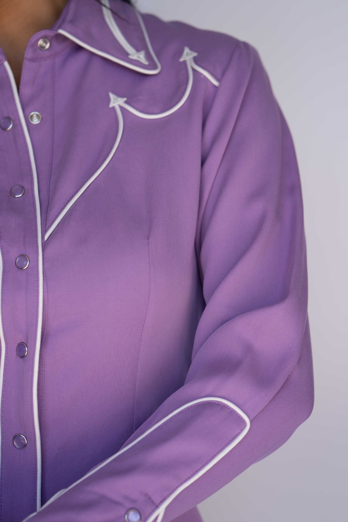 Yoke and placket detail of the H Bar C Lake Tahoe lavender western shirt with white piping.