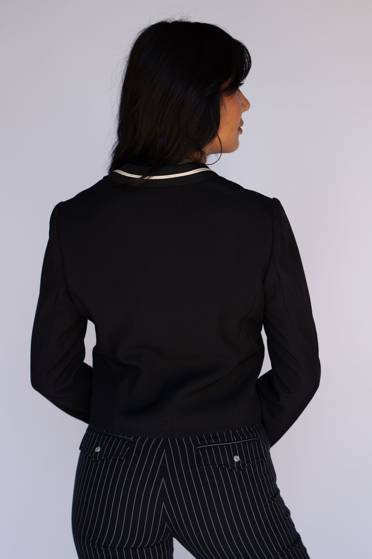 Back view of the H Bar C Calamity women's black jacket with cream collar trim.