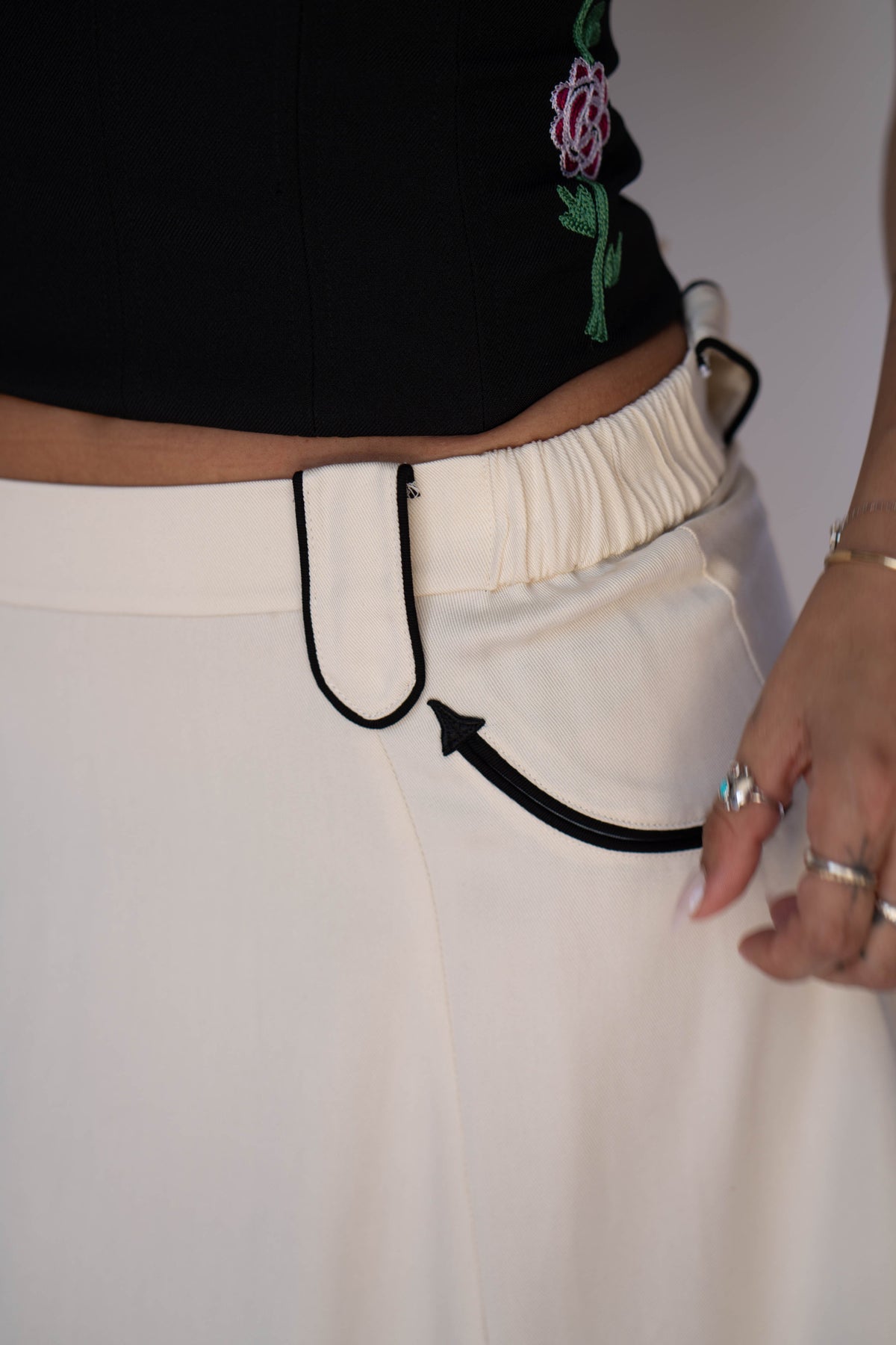 Close-up of the black piped arrow pocket on the H Bar C Santa Fe off white skirt.