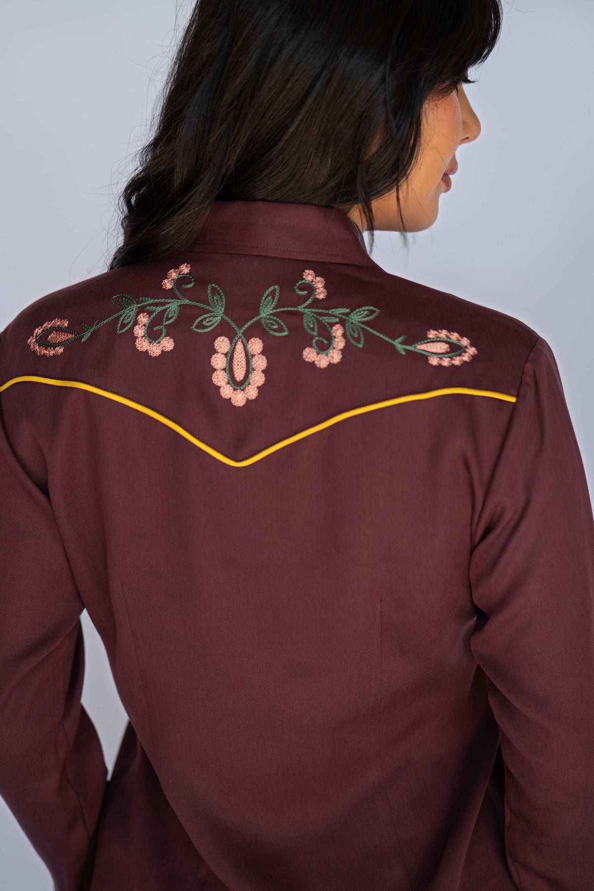 Back shoulder view of the H Bar C Sedona maroon dress with yellow piped yoke.