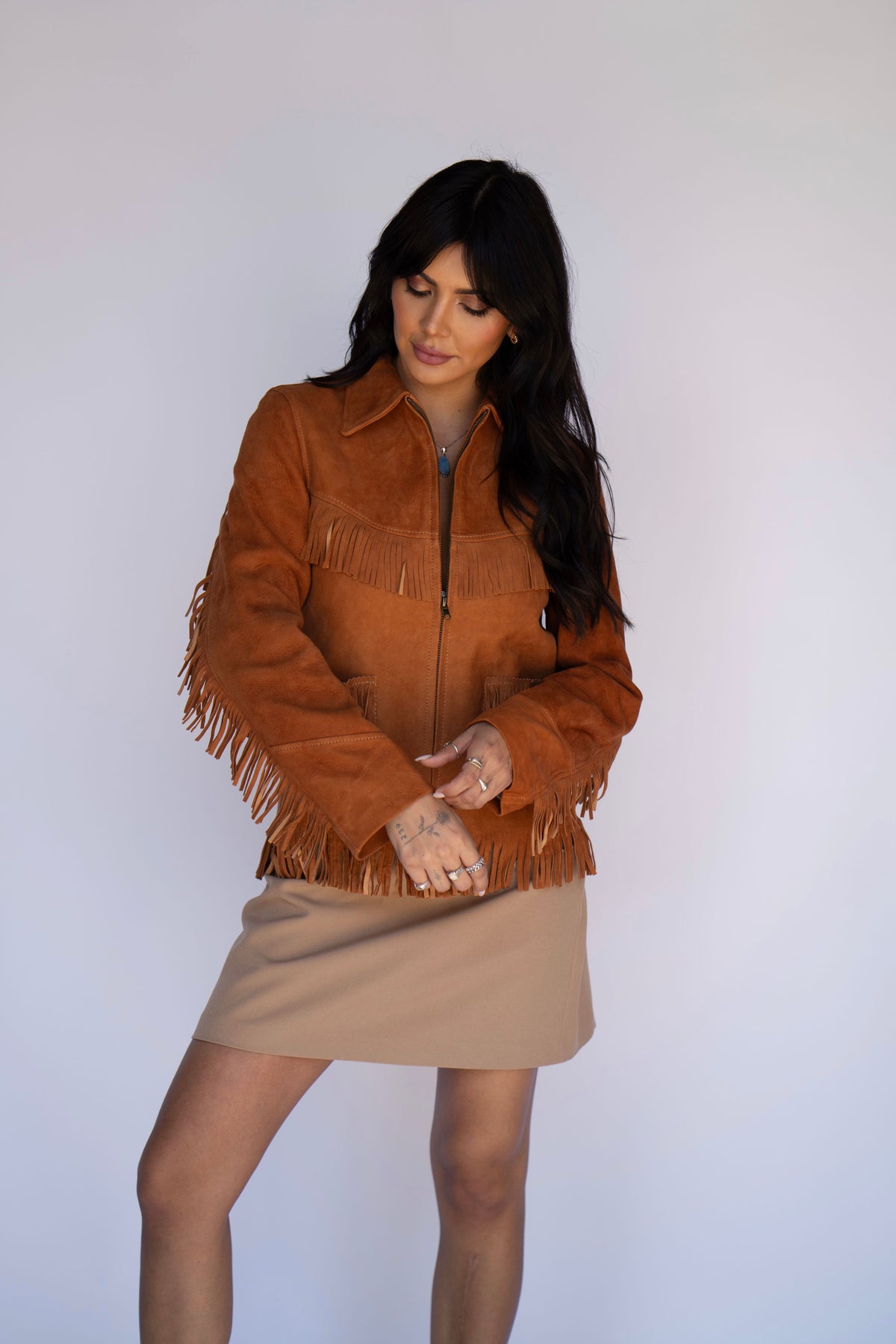 Woman posing in the H Bar C Omaha vintage reproduction suede fringe jacket.
