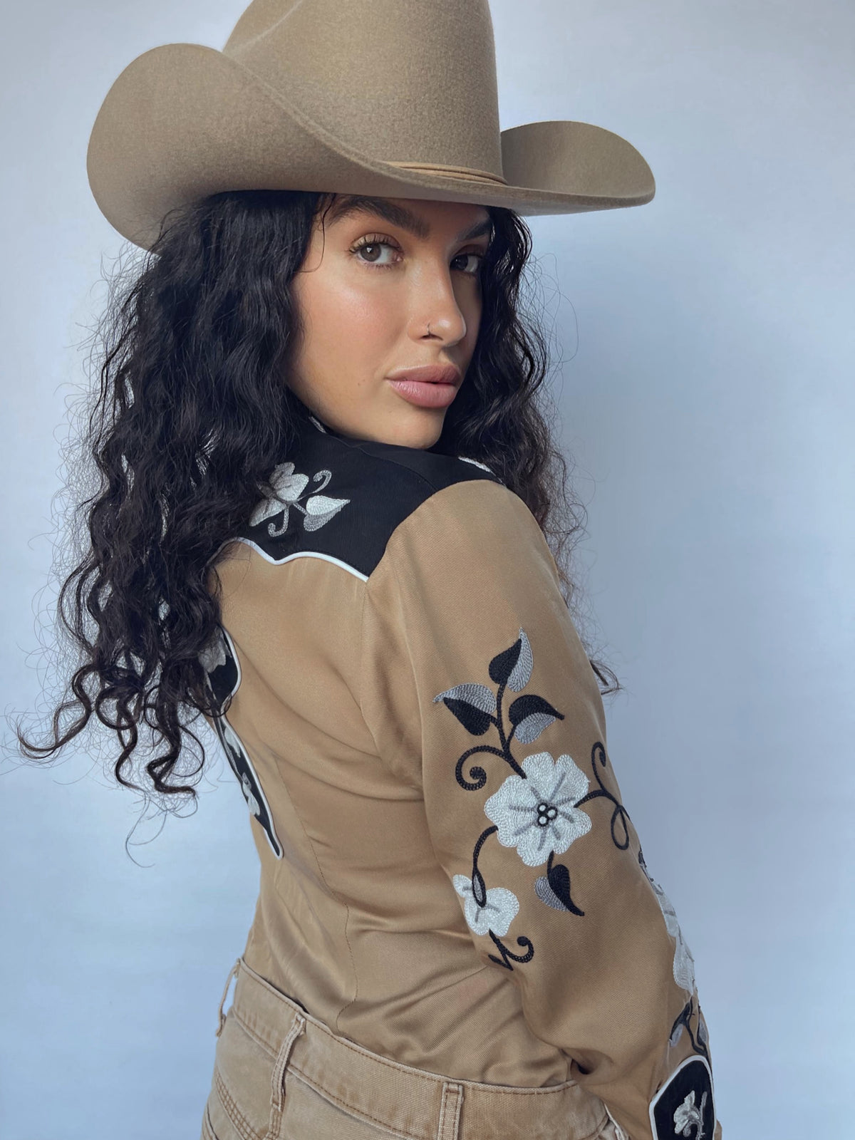 Woman looking over her shoulder in the H Bar C Santa Ana tan floral western shirt.