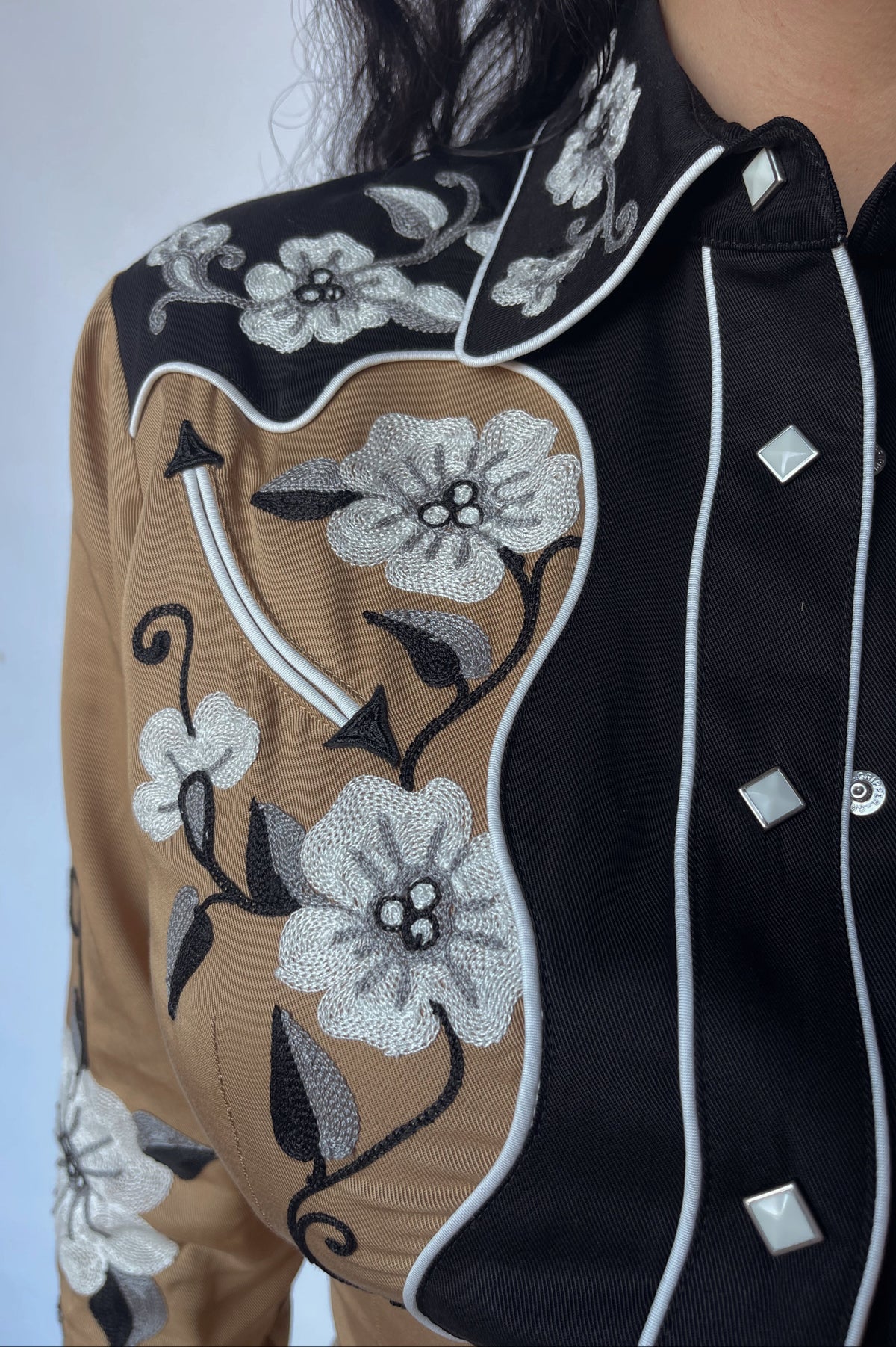 Close-up of the black yoke and white floral embroidery on the H Bar C Santa Ana tan women's shirt.