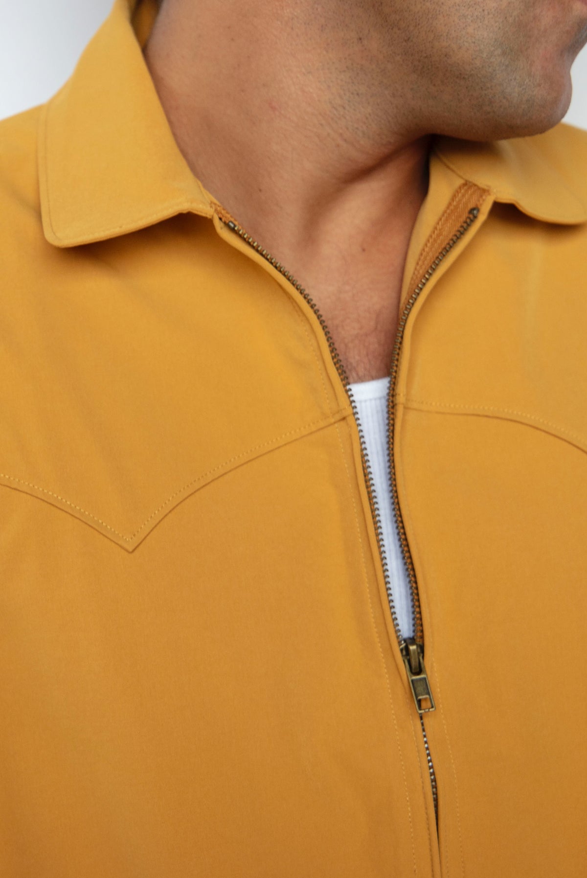 Collar and zipper close-up of the H Bar C Mustang mustard yellow jacket.