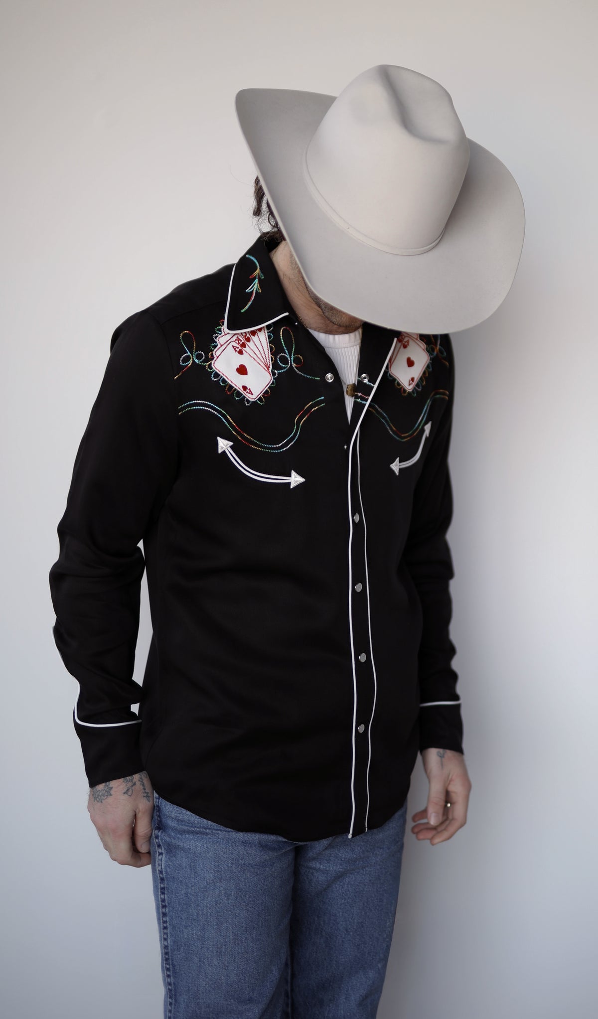 H Bar C Royal Flush black casino themed western shirt worn with jeans and a cowboy hat.