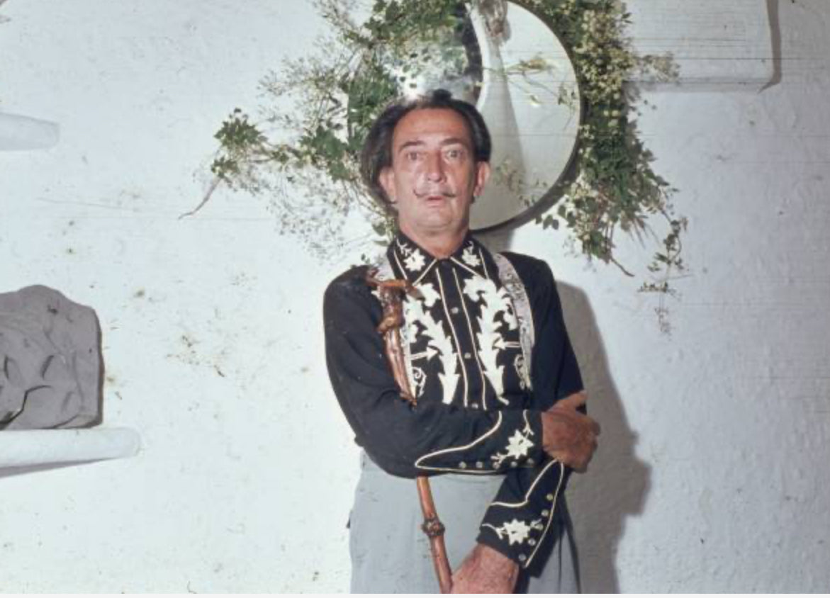 Archival photo of Salvador Dalí in a black H Bar C western shirt with white embroidery.