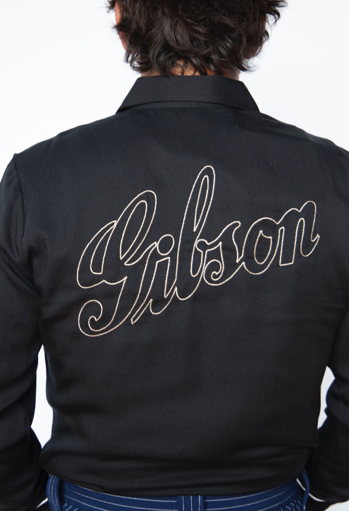 Back of the HBarC x Gibson J-200 men's shirt with Gibson script chain stitch embroidery.