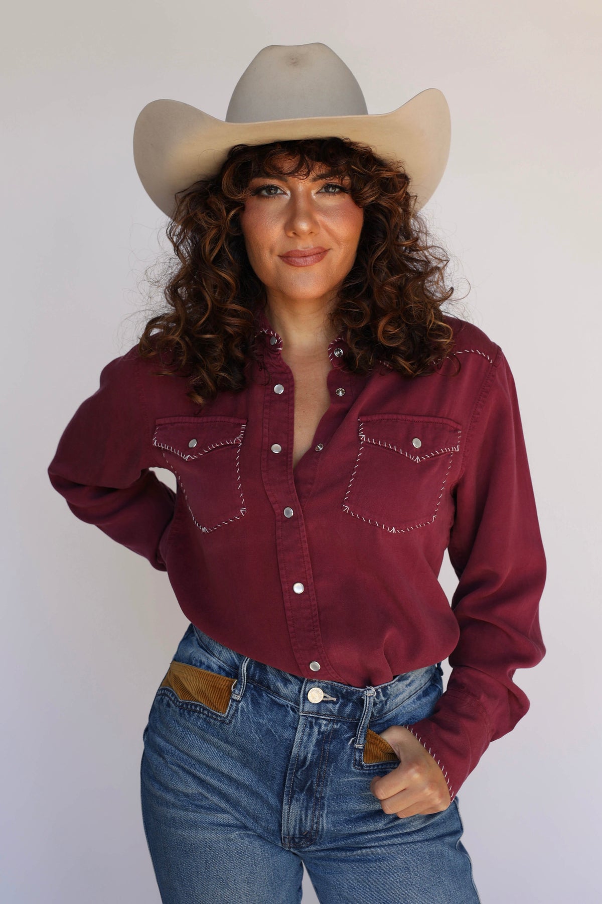Model in the H Bar C Brooklyn women's wine shirt with stitched pockets and jeans.