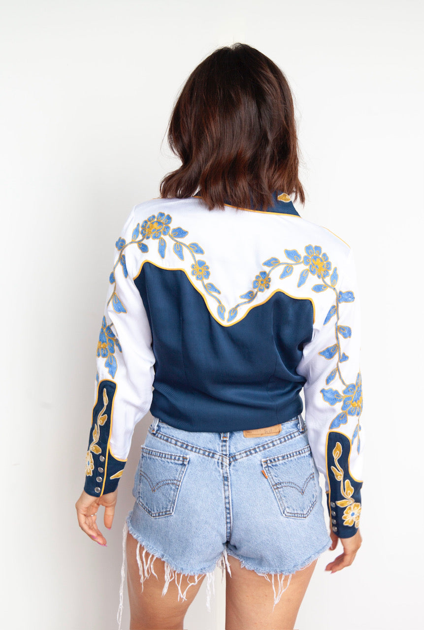 Back view of the H Bar C Charleston blue shirt with gold chain stitch flowers on the white back yoke.