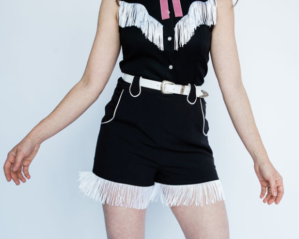 H Bar C Marfa black shorts with white fringe hem and white belt.