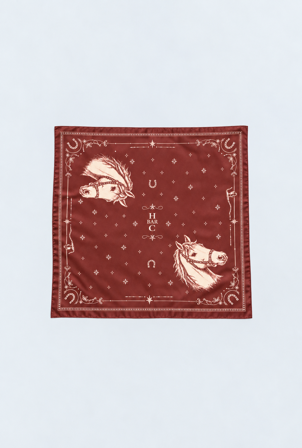 H Bar C Maroon Horse silk scarf laid flat, maroon western bandana with two cream horse heads, horseshoes, stars, and the H Bar C monogram.