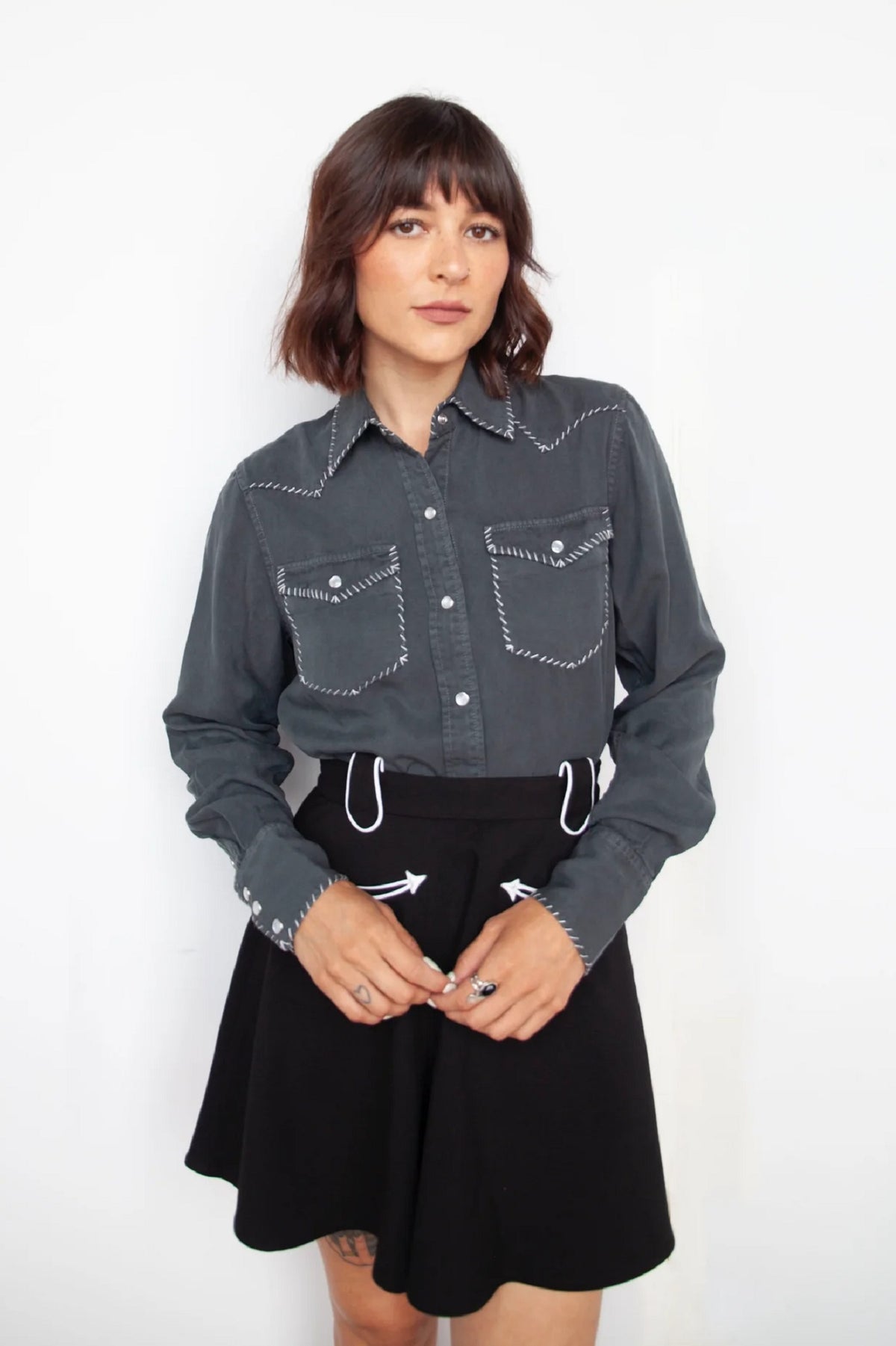 Woman wearing the H Bar C Brooklyn charcoal slate western shirt with a black skirt.