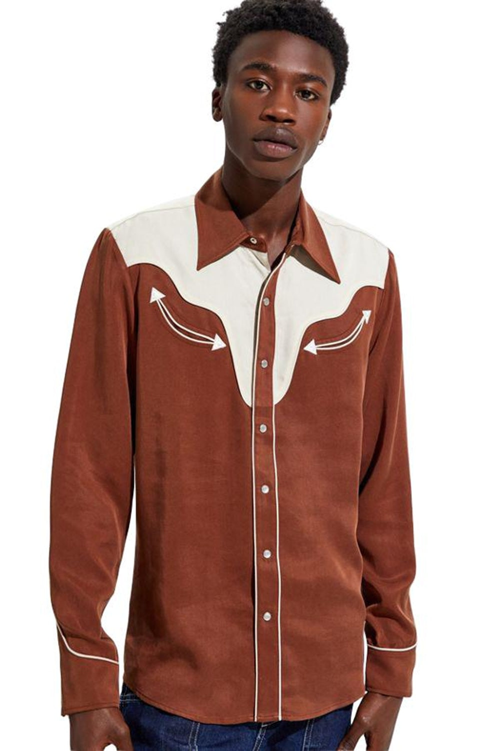 Man wearing the H Bar C San Juan men's shirt in brown with a contrasting cream yoke and piping, with jeans.