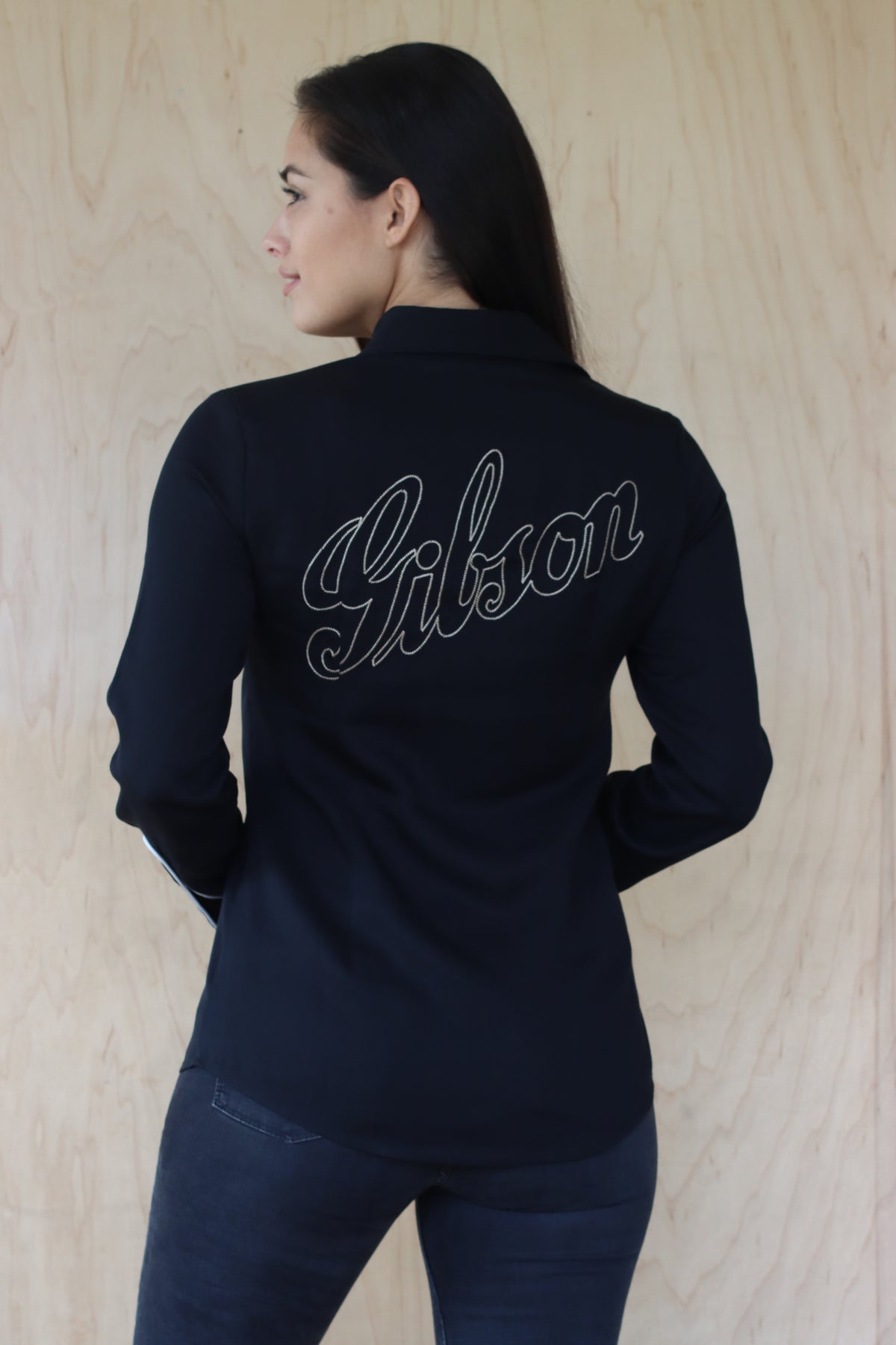 Back view of the HBarC x Gibson J-200 women's black shirt with white Gibson logo embroidery.